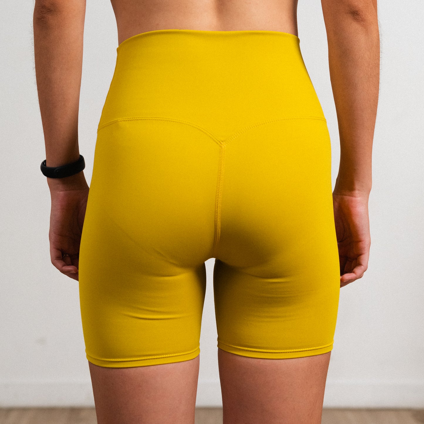 Mustard Earth Sara shorts in sweat-wicking stretch fabric designed for training and lifestyle movement.